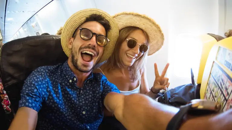 millennials life insurance man and woman on plane smiling